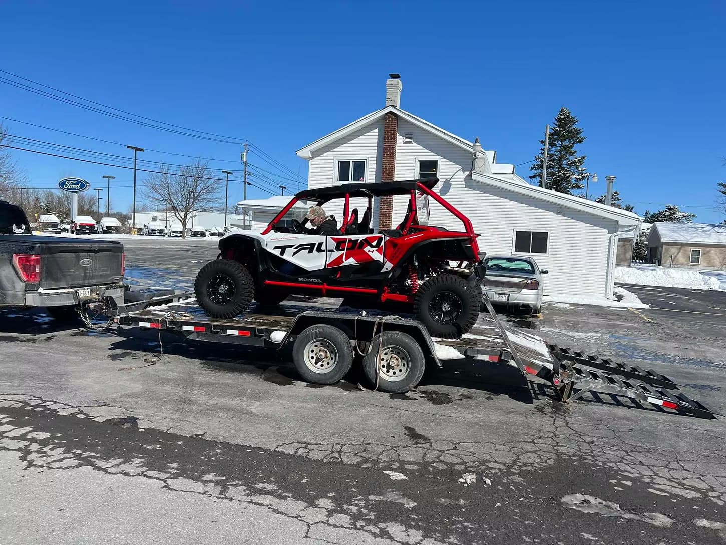 Powersports vehicle on trailer at the shop